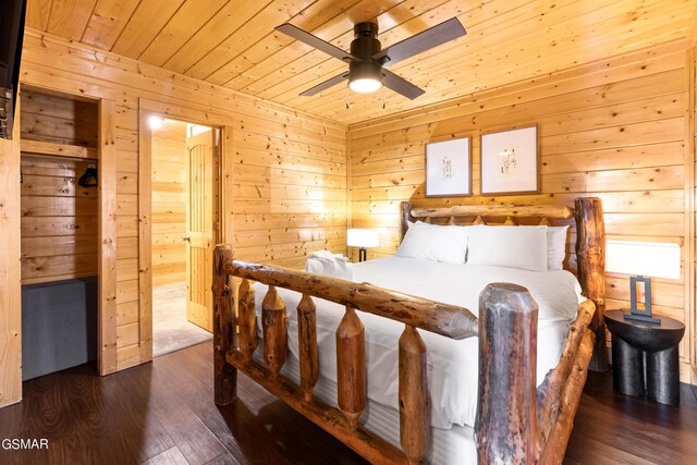 bedroom featuring ceiling fan, wooden ceiling, dark hardwood / wood-style floors, and wood walls