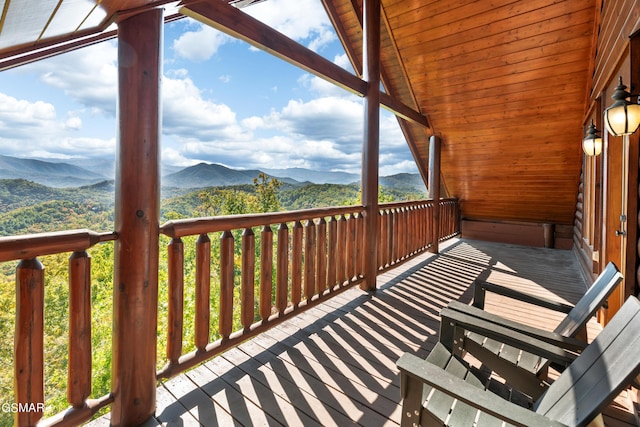 wooden deck with a mountain view