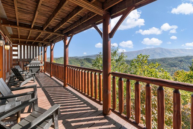 deck with area for grilling and a mountain view