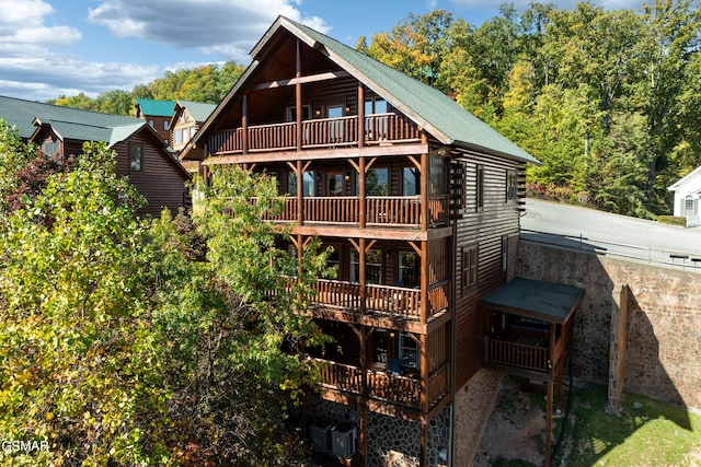 back of house with a balcony and central AC unit