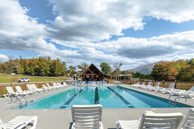 view of swimming pool with a mountain view