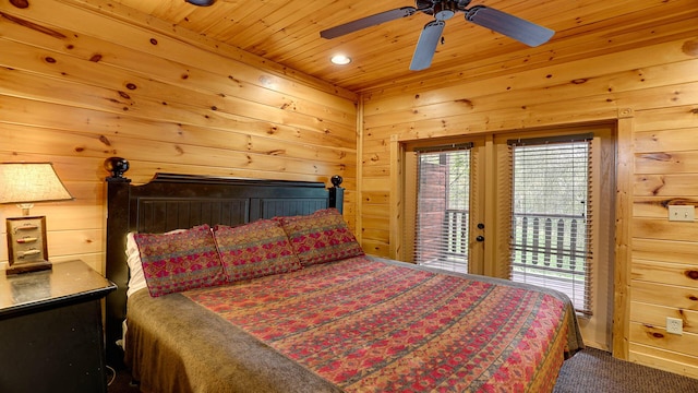 carpeted bedroom featuring ceiling fan, wood walls, access to exterior, and wood ceiling