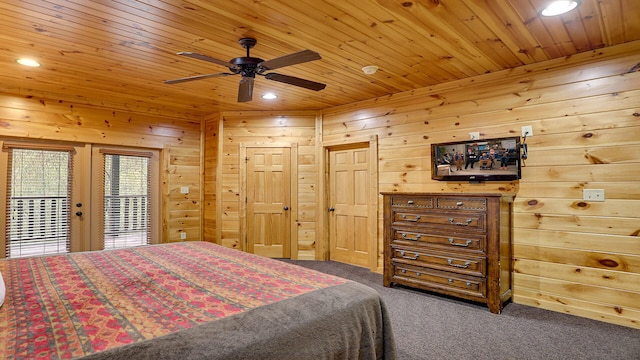 carpeted bedroom with ceiling fan, wood walls, wood ceiling, and access to outside