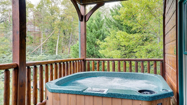 wooden deck featuring a hot tub