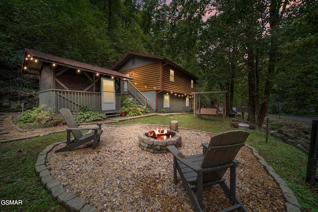 back of house featuring a fire pit