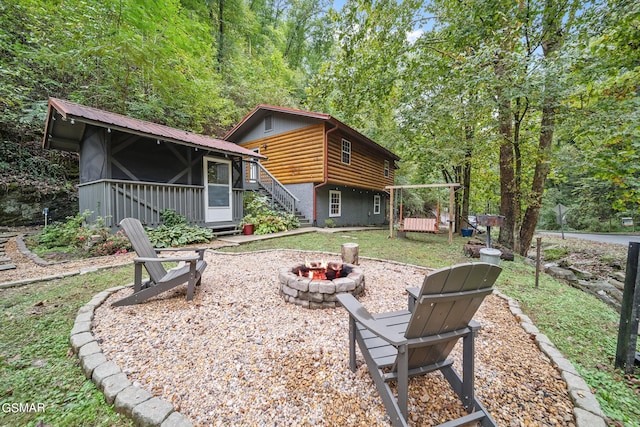 back of house featuring a fire pit