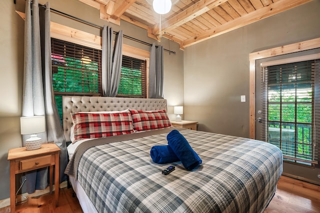 bedroom with hardwood / wood-style floors, beam ceiling, and wood ceiling