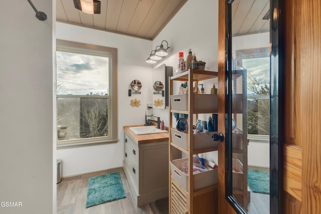 bathroom with vanity, wood ceiling, and hardwood / wood-style flooring