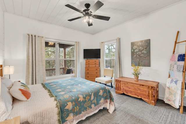 carpeted bedroom featuring wood ceiling and ceiling fan