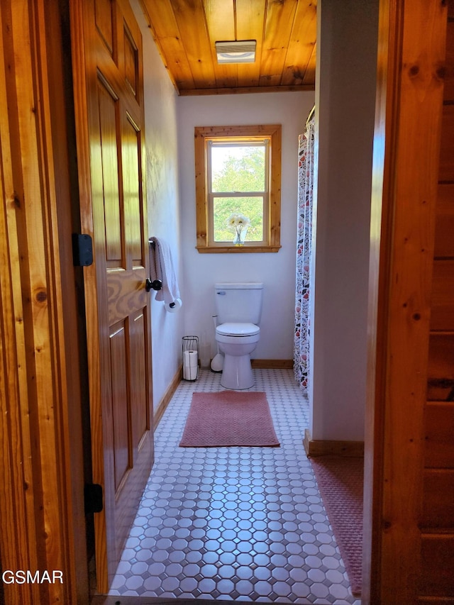 bathroom with toilet and wood ceiling