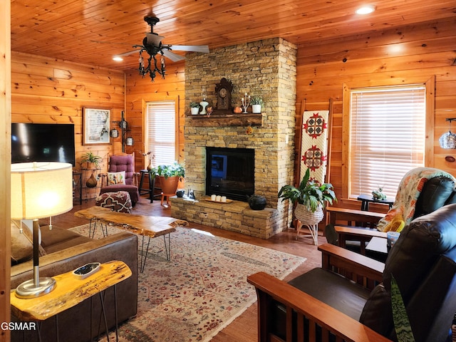 living room with ceiling fan, hardwood / wood-style floors, wooden ceiling, and wooden walls