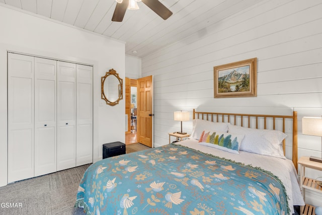 bedroom with ceiling fan, wood ceiling, and a closet