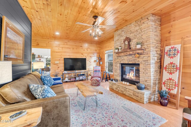 kitchen featuring decorative light fixtures, wood-type flooring, appliances with stainless steel finishes, and vaulted ceiling