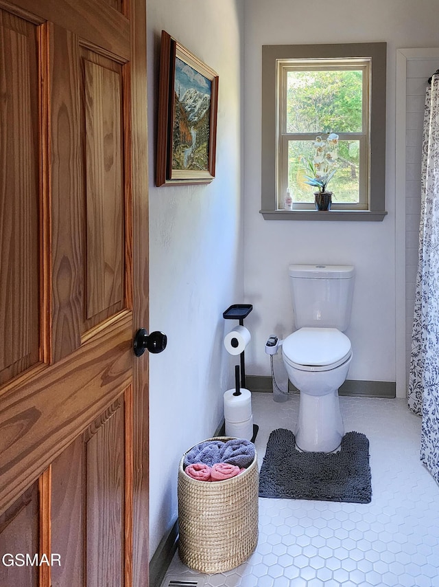 bathroom featuring toilet and walk in shower