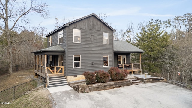 back of property with covered porch