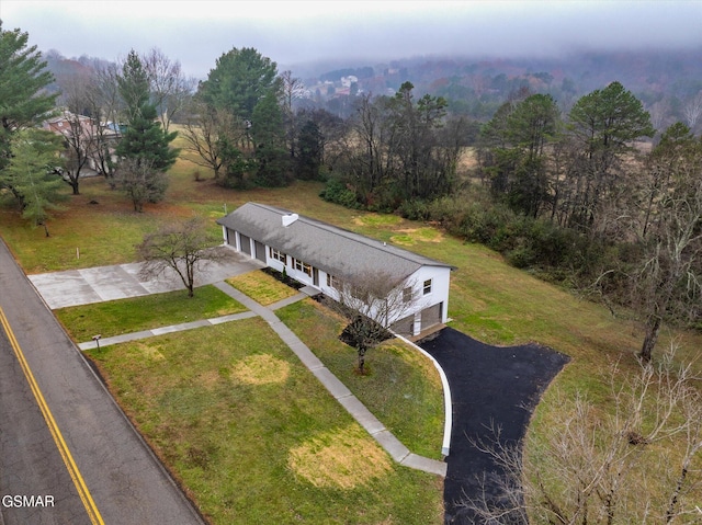 birds eye view of property with a forest view