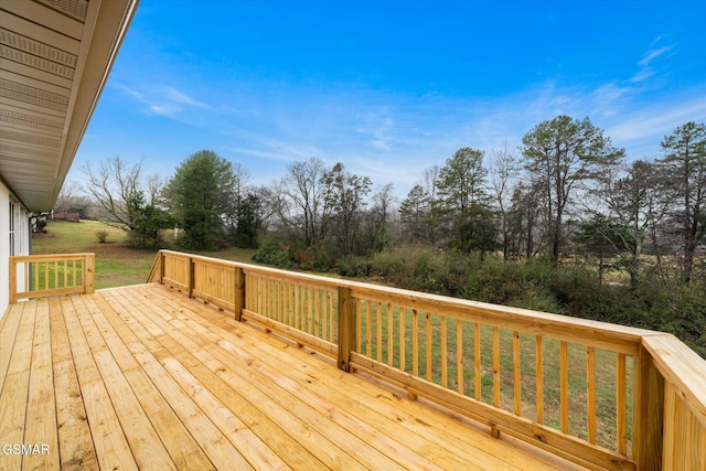 wooden terrace featuring a yard