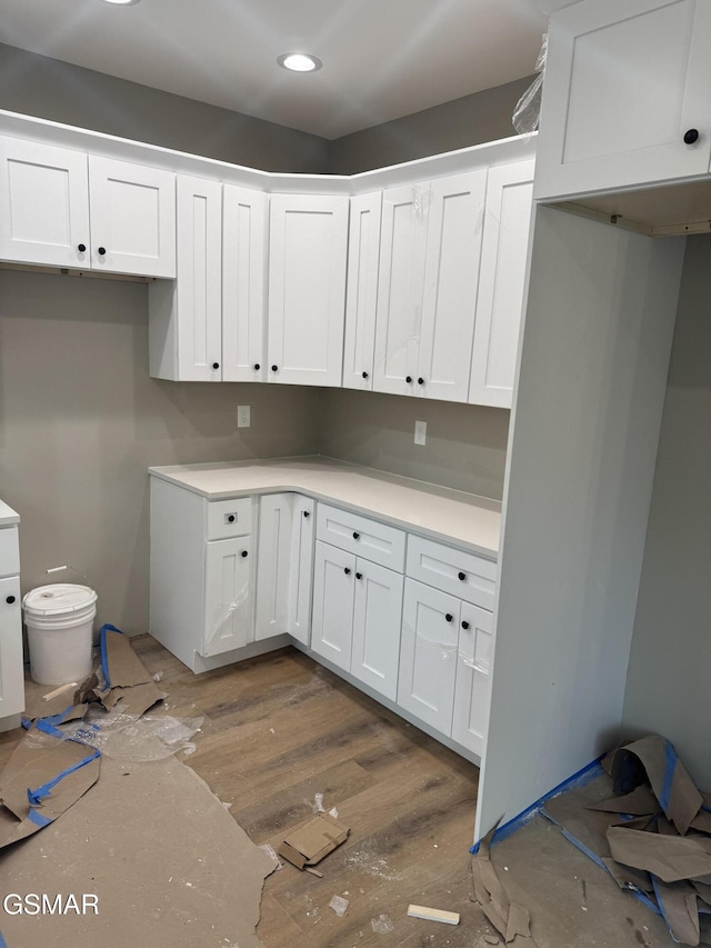 kitchen featuring white cabinets, light countertops, and recessed lighting
