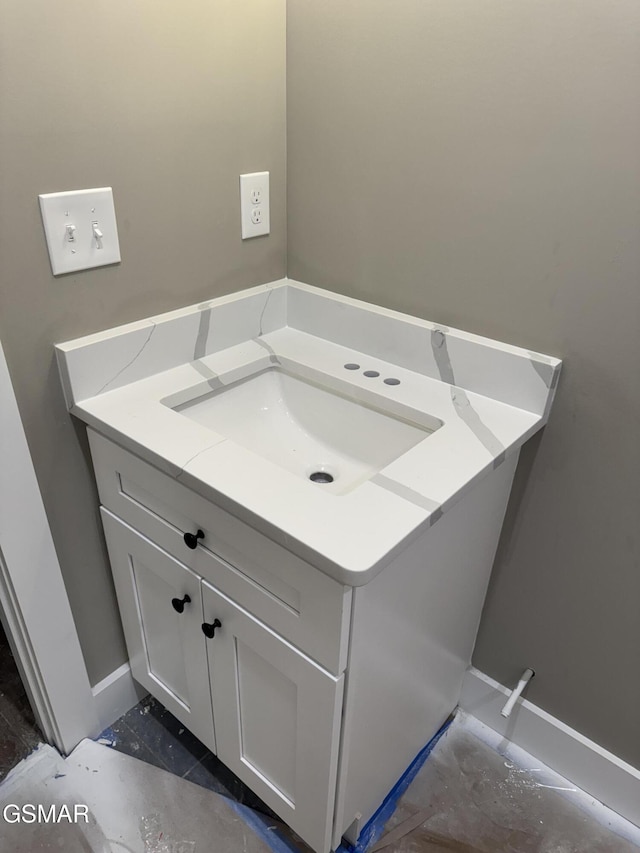 bathroom featuring baseboards and vanity