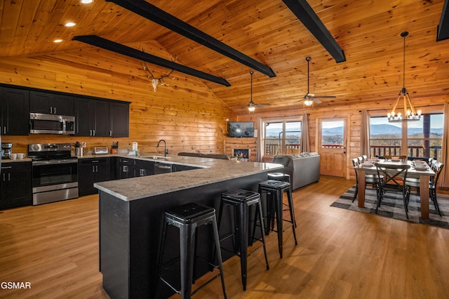 kitchen with wooden ceiling, appliances with stainless steel finishes, beam ceiling, and high vaulted ceiling