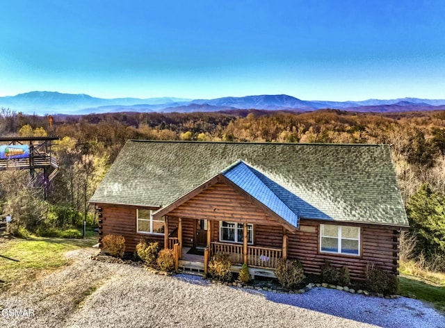 cabin with covered porch and a mountain view