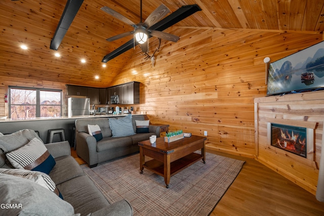 living room with wood ceiling, wooden walls, and light hardwood / wood-style flooring