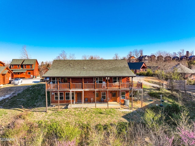 back of property with a wooden deck and central air condition unit