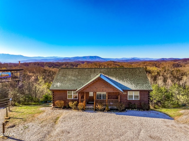 log home featuring a mountain view and a porch