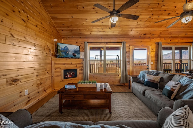 living room with ceiling fan, hardwood / wood-style floors, high vaulted ceiling, and wooden ceiling