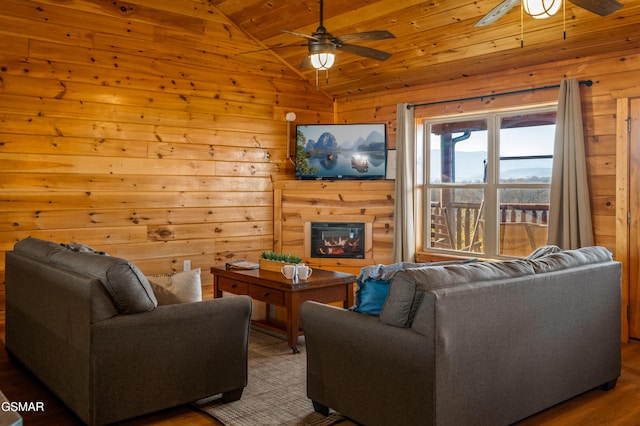 living room with hardwood / wood-style floors, wood ceiling, wooden walls, vaulted ceiling, and ceiling fan