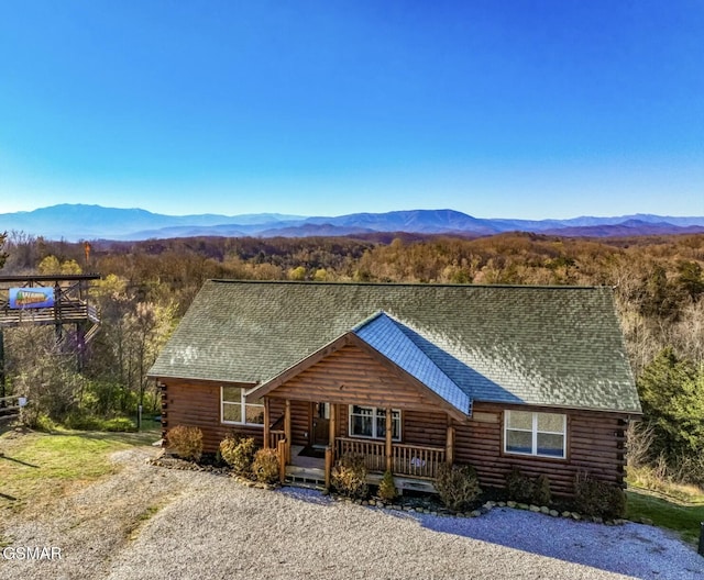 log home featuring a mountain view and covered porch