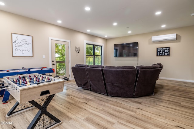 living room featuring an AC wall unit and light wood-type flooring