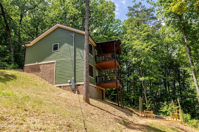 view of side of home with a balcony