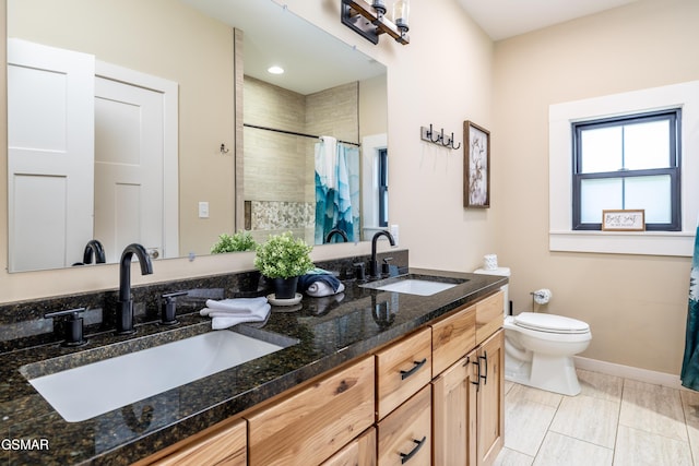 bathroom with toilet, vanity, tile patterned floors, and curtained shower