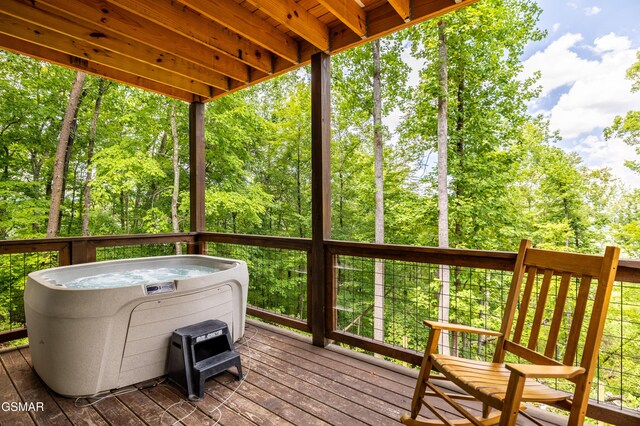 wooden terrace featuring a hot tub