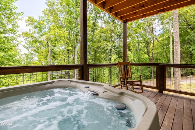 deck with an outdoor hot tub