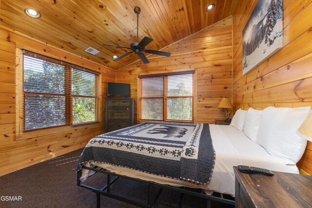 carpeted bedroom with ceiling fan, wood walls, lofted ceiling, and wood ceiling