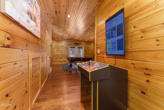 rec room with french doors, dark wood-type flooring, wooden ceiling, billiards, and wood walls