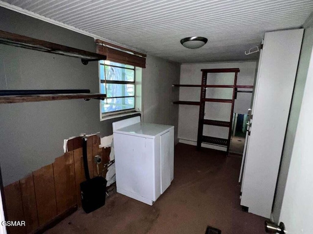 basement featuring refrigerator and washer / dryer