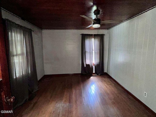 empty room with hardwood / wood-style floors and ceiling fan