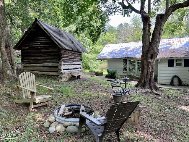 view of yard with an outbuilding and an outdoor fire pit