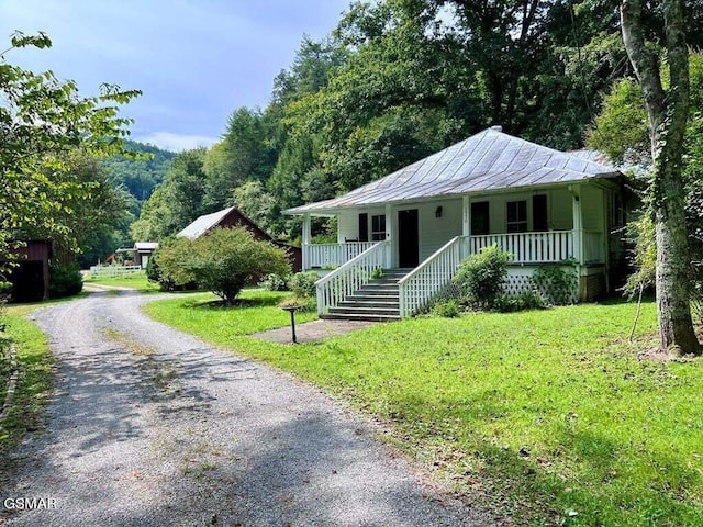 view of front of house featuring covered porch and a front lawn