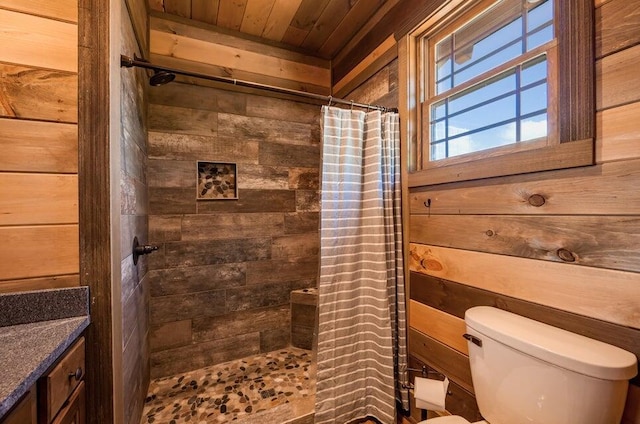 bathroom with vanity, wooden ceiling, wooden walls, toilet, and walk in shower