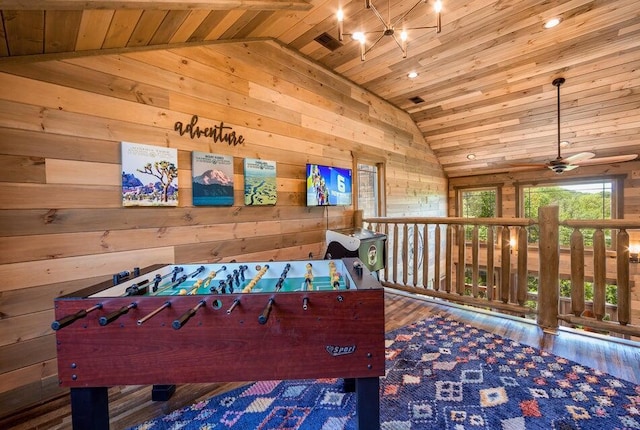 game room with wooden walls, vaulted ceiling, hardwood / wood-style flooring, ceiling fan, and wood ceiling