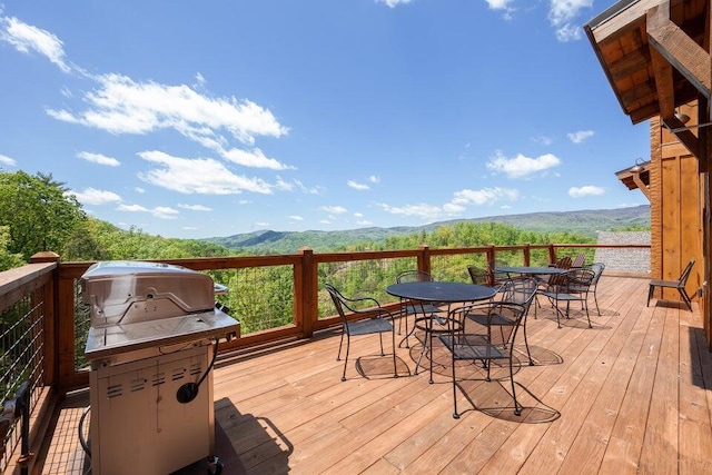 wooden terrace with grilling area and a mountain view