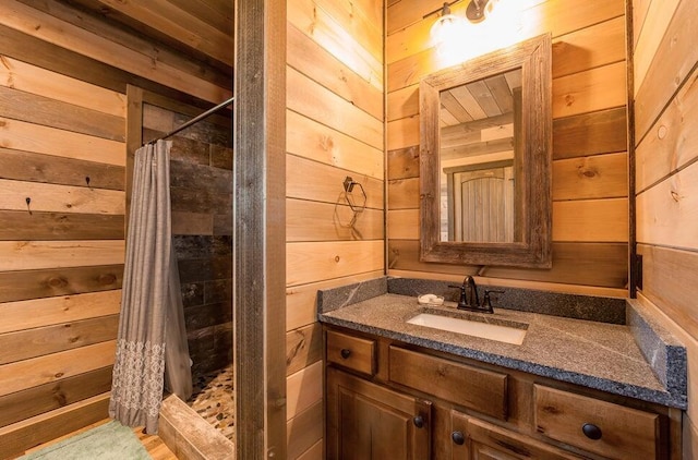 bathroom featuring wooden walls, vanity, and a shower with shower curtain