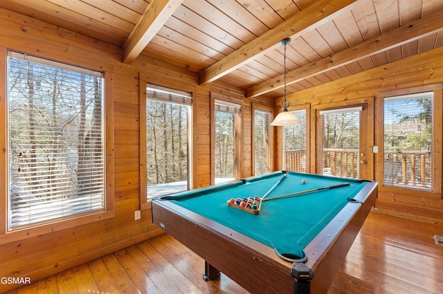 playroom with wood walls, plenty of natural light, hardwood / wood-style floors, and beam ceiling