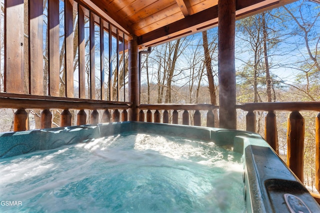 wooden deck with a hot tub