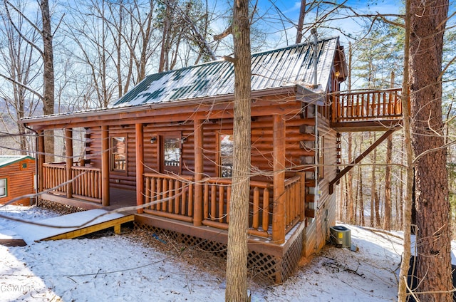 snow covered deck featuring central air condition unit