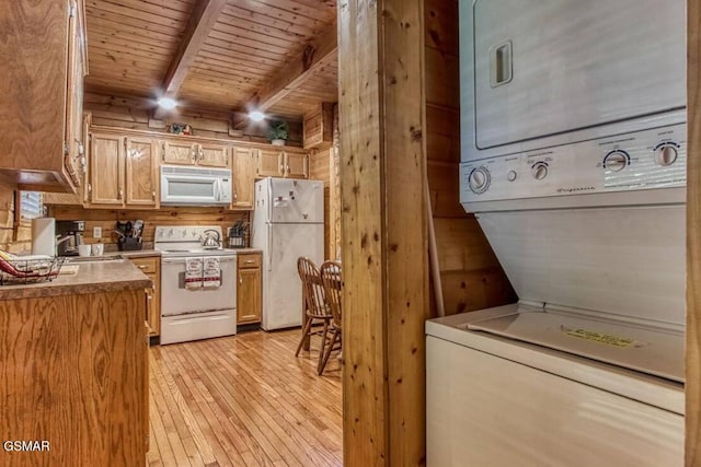 kitchen featuring stacked washer / drying machine, wooden walls, wooden ceiling, white appliances, and beamed ceiling